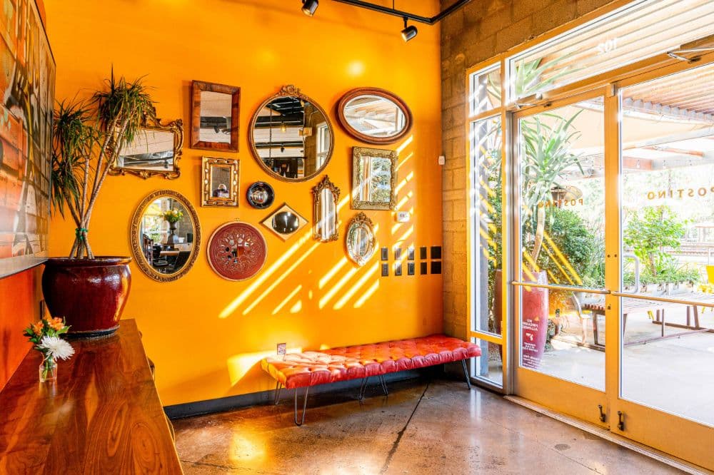 Yellow walls with mirrors and artwork.