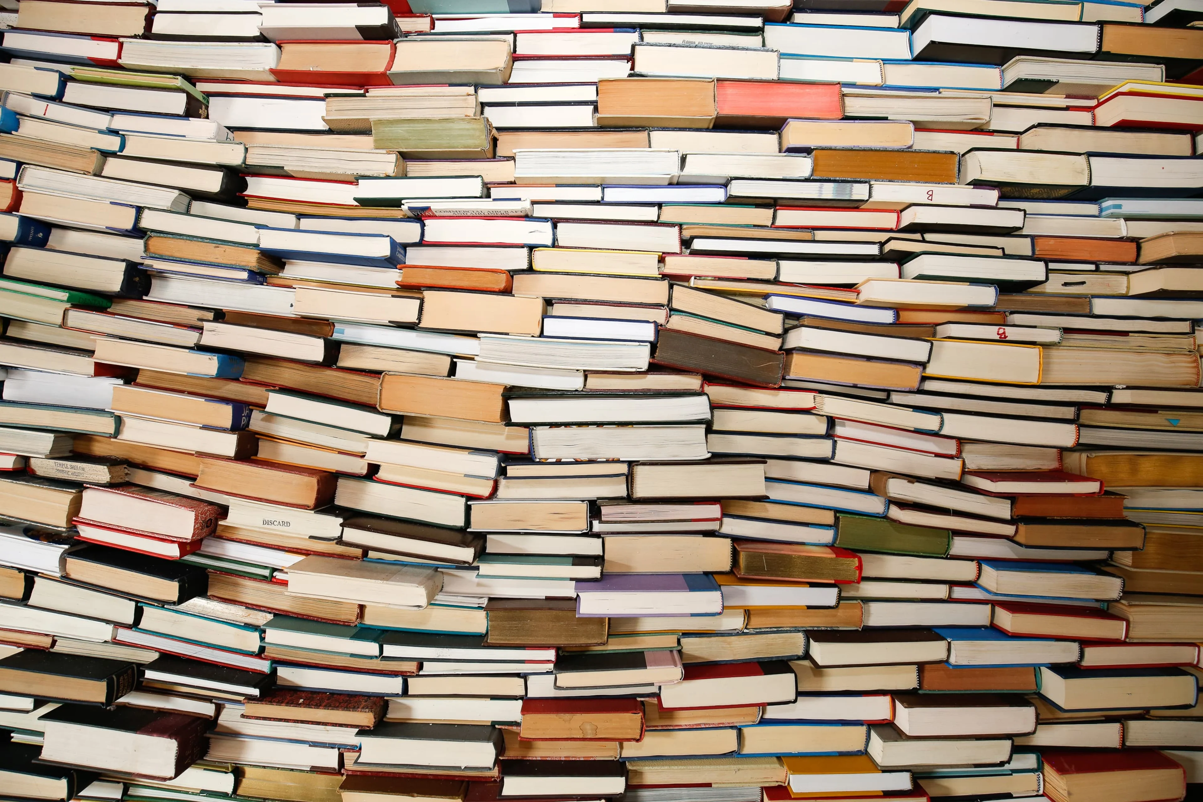 Wall of colorful books stacked.