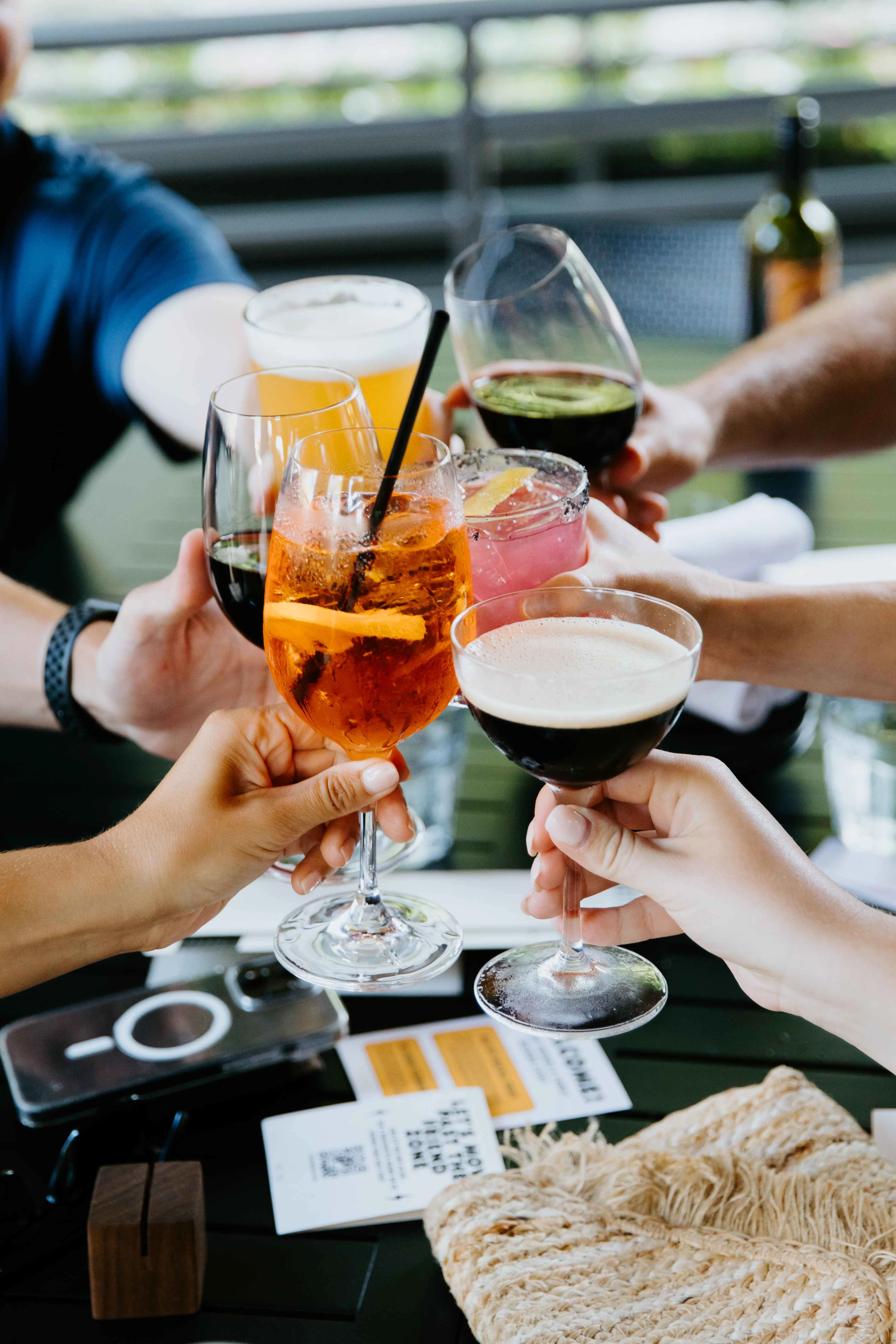Group of guests cheering wine, beer, and cocktails