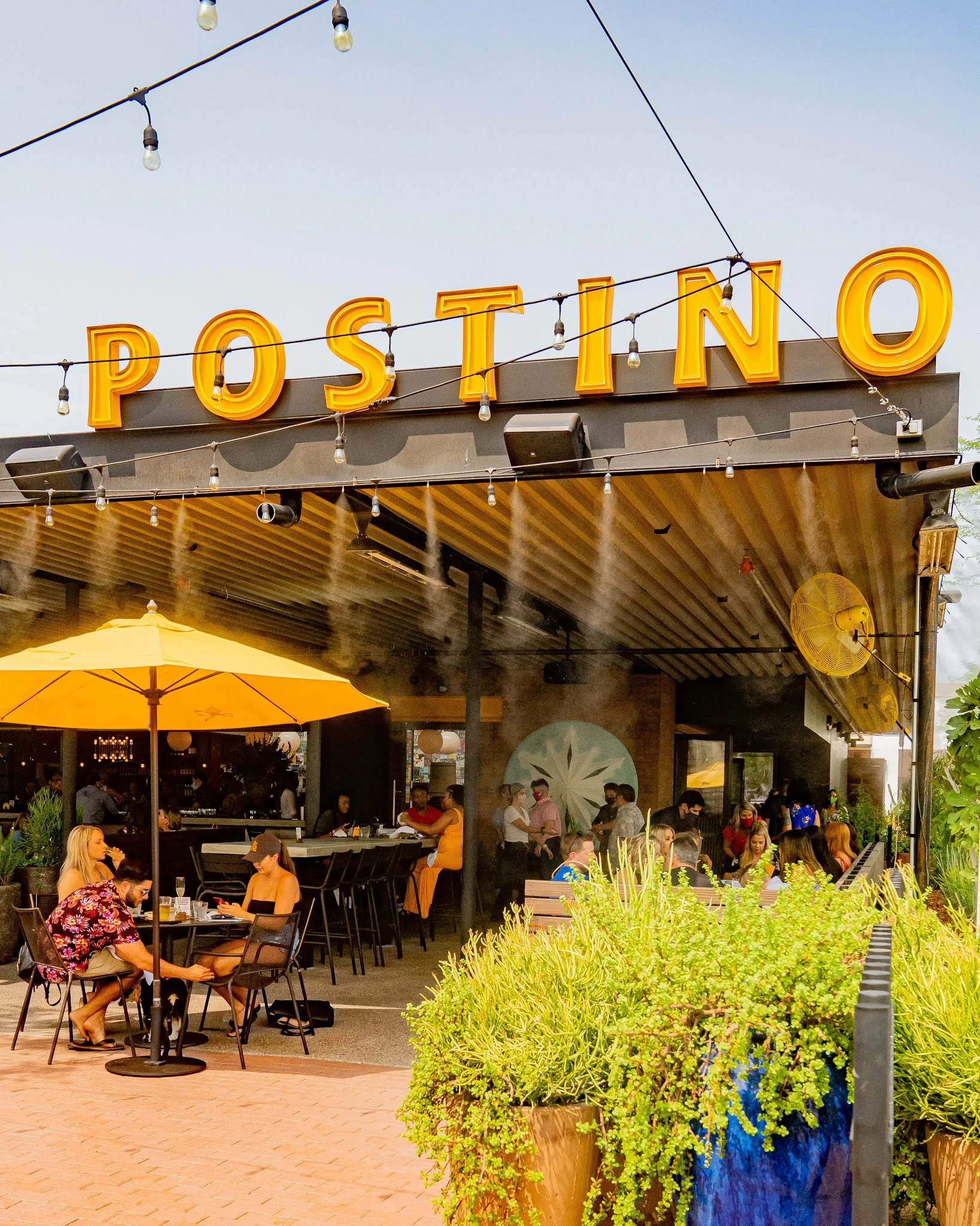 A large yellow sign that says Postino.