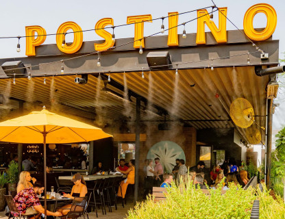 A large yellow sign that says Postino.