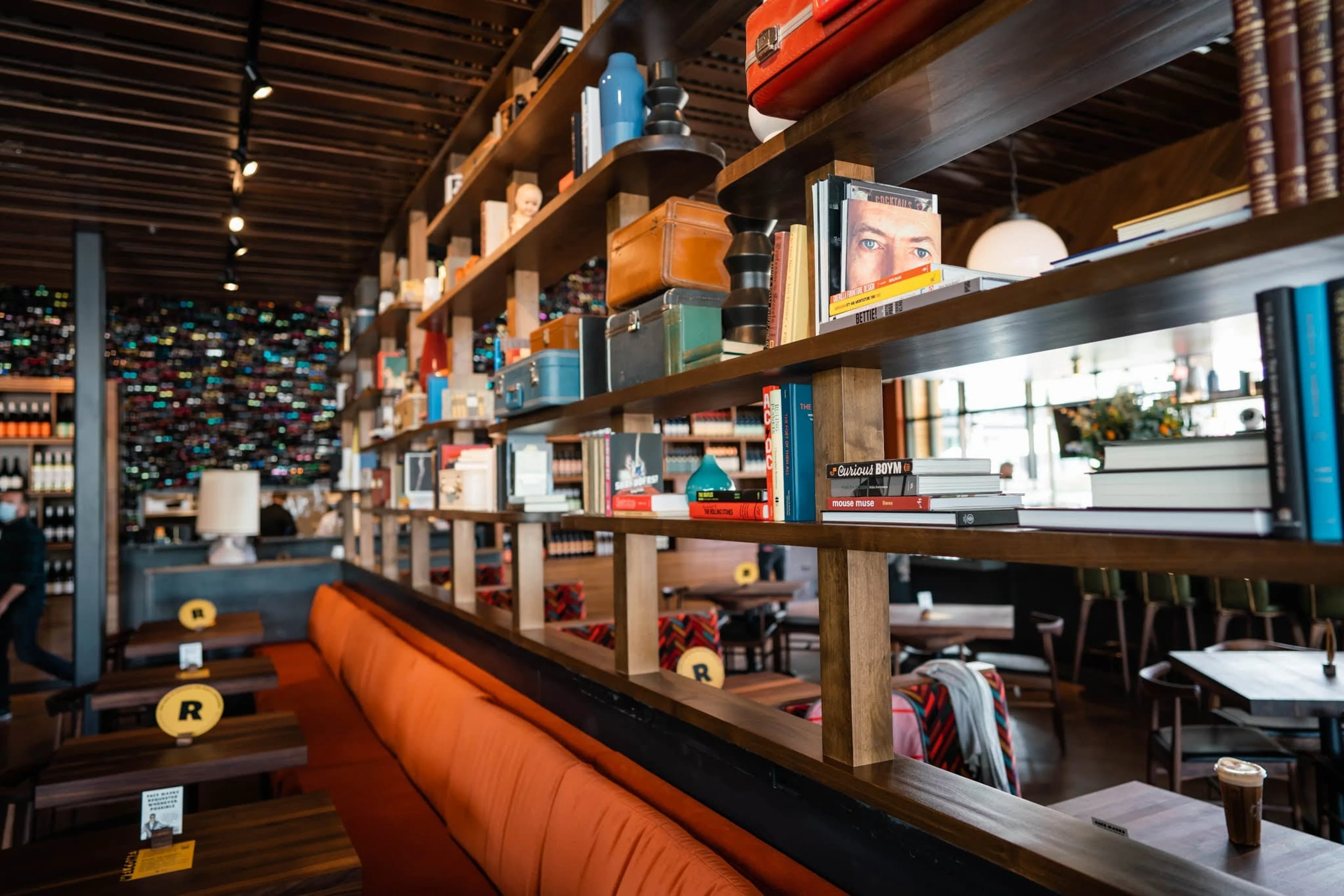 long orange couch with shelves