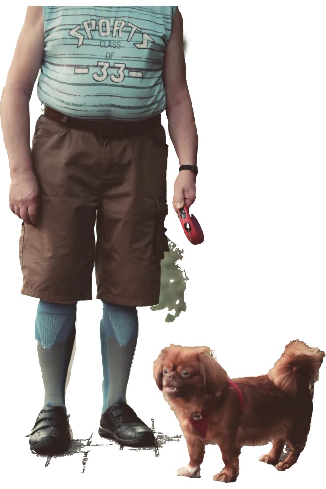 Photo of a man walking a small dog