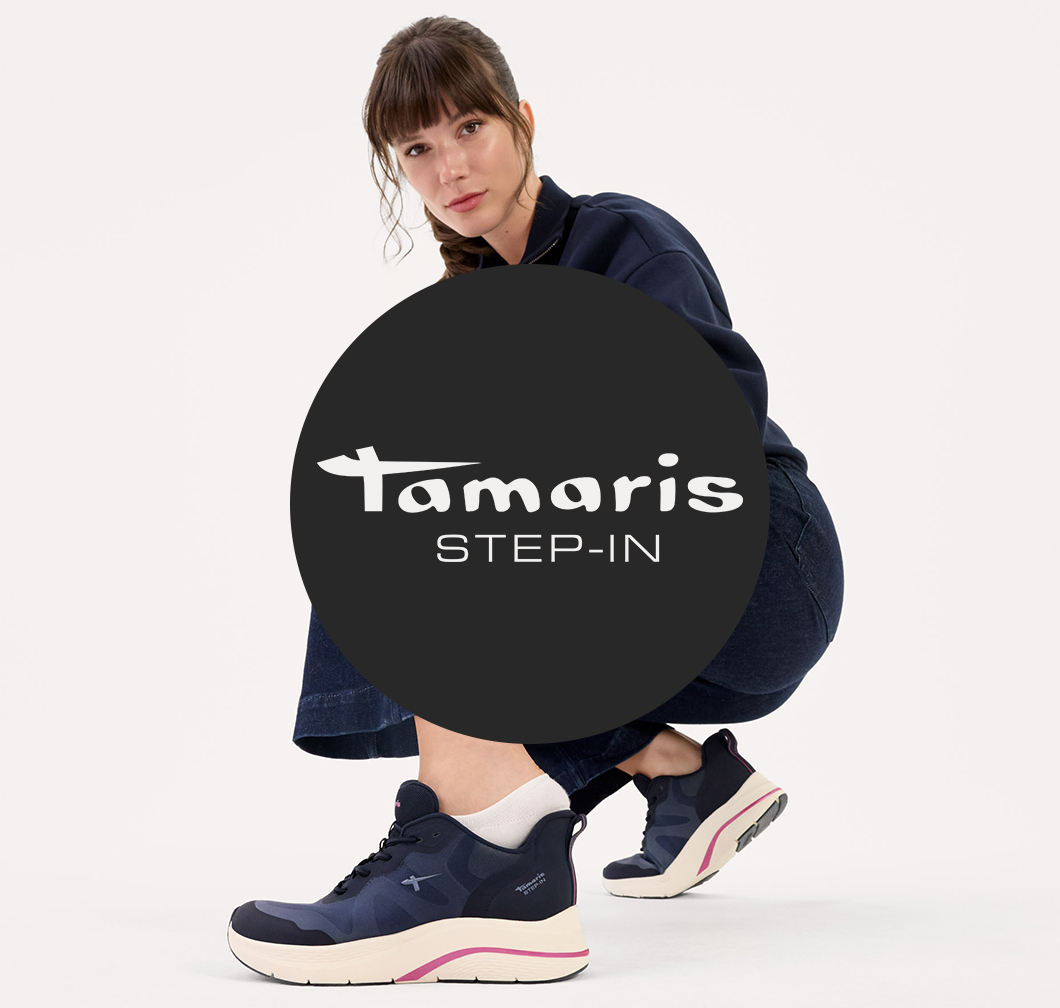 Foto pubblicitaria alla moda per le scarpe Tamaris Step-In con design blu scuro e accenti bianchi su sfondo bianco.