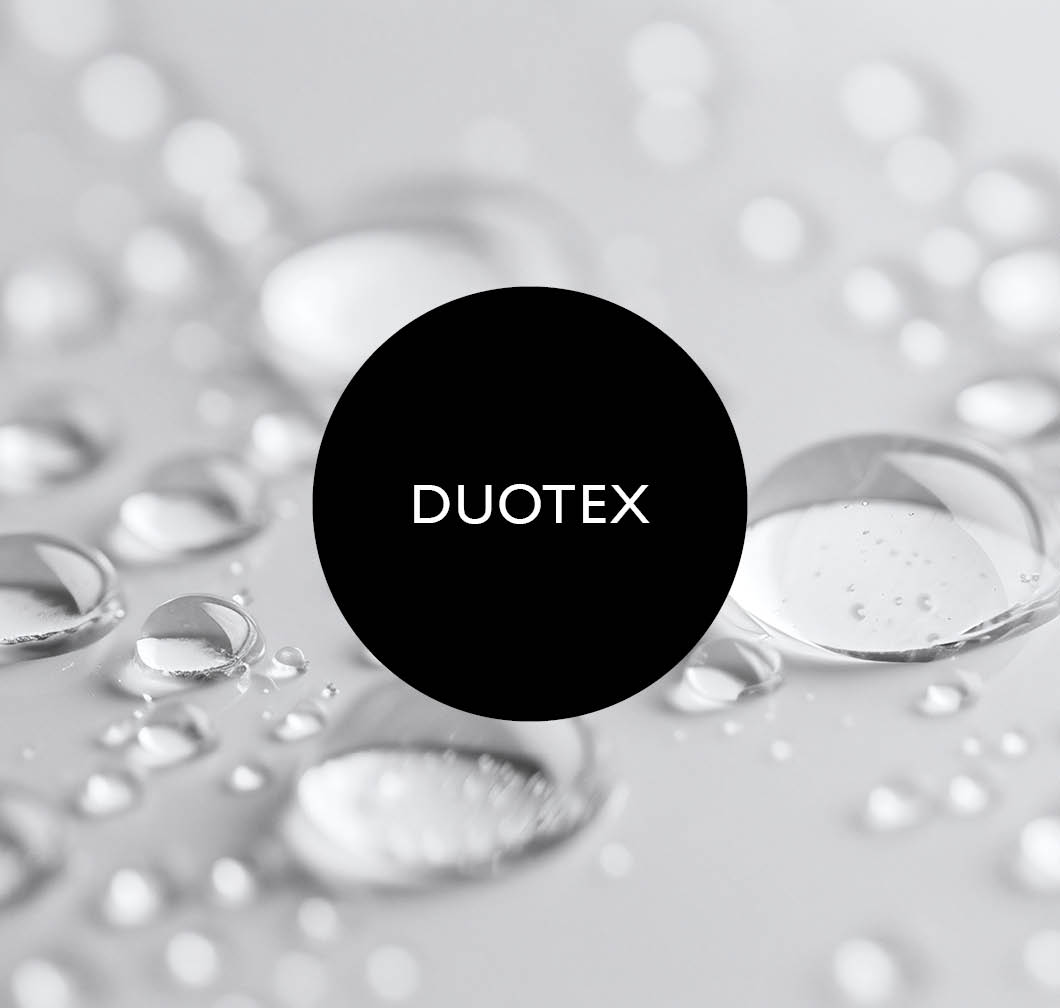 Close‑up of water droplets on a grey surface, with a black circle and white &ldquo;DUOTEX&rdquo; lettering in the centre.