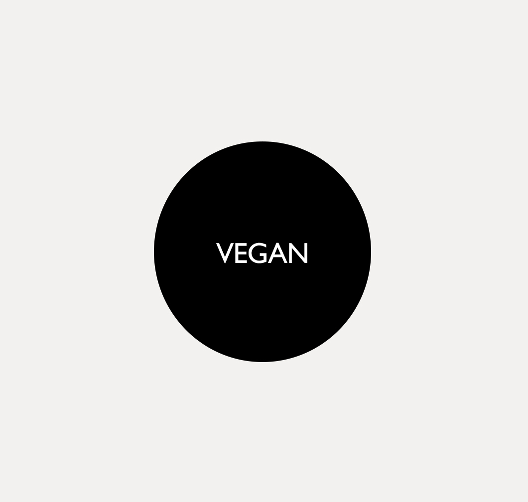 Black round icon with the white lettering "VEGAN" on a light background.