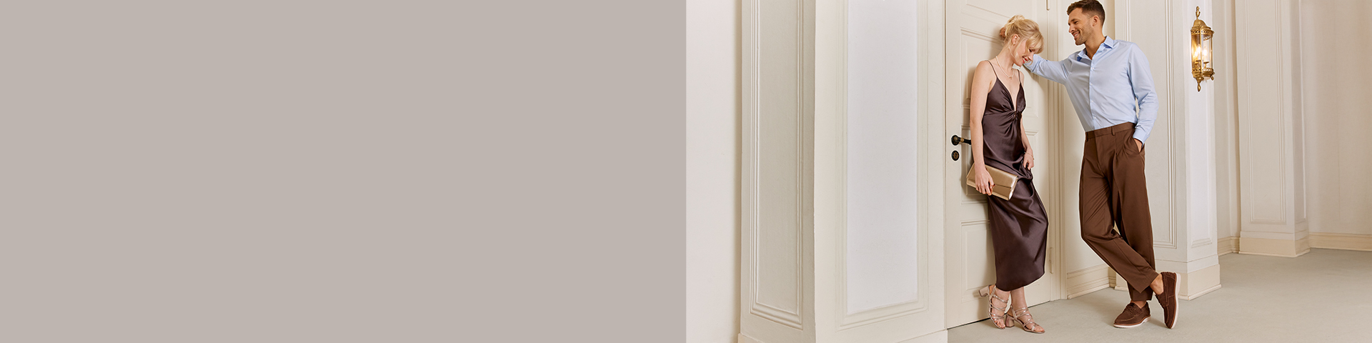 Various elegant shoes on wooden floor: sparkling pumps, flat sandals and sneakers in champagne and white tones.