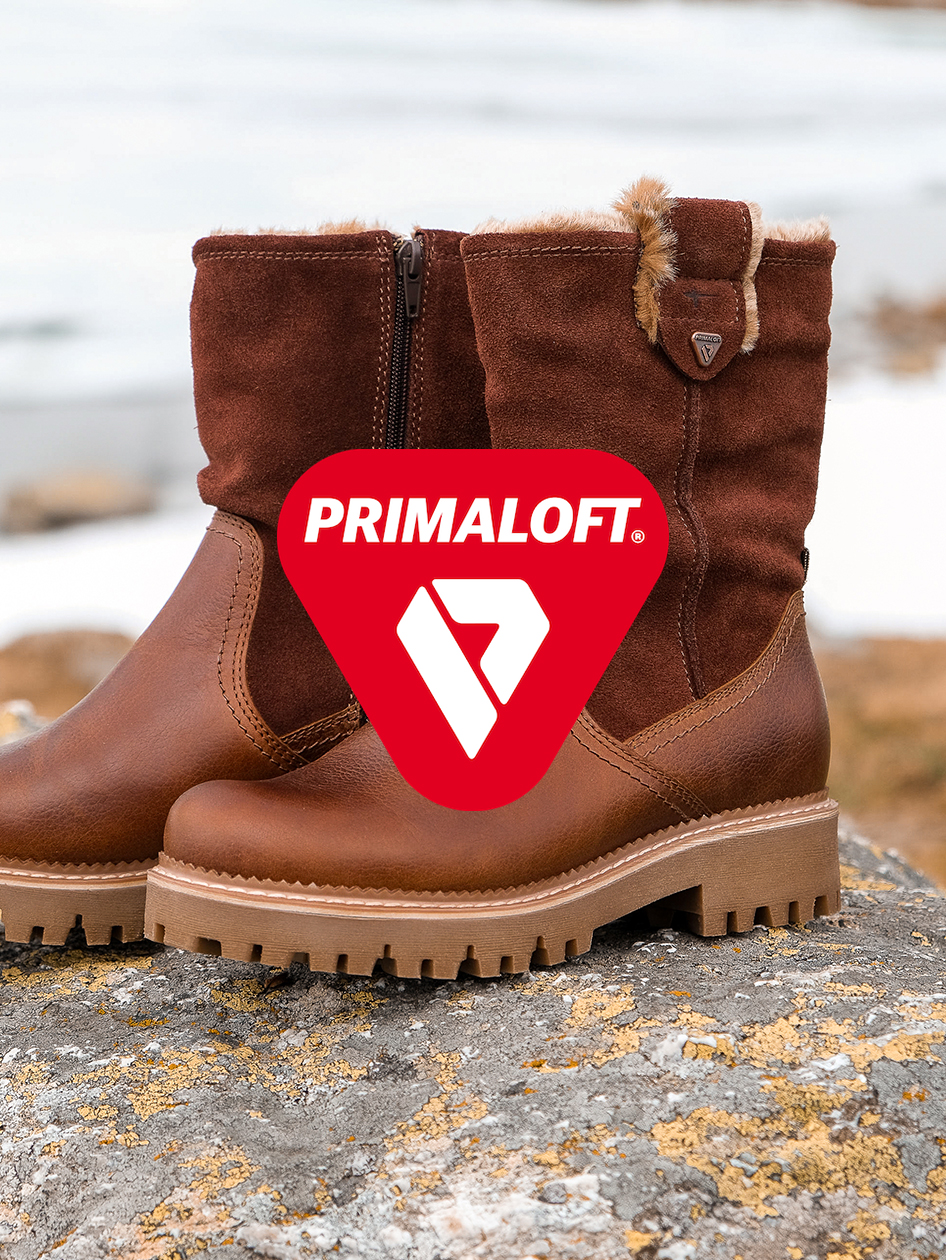 Bottes d'hiver marron avec isolation Primaloft, semelle profilée robuste et fermeture éclair latérale sur Fond caillouteux.