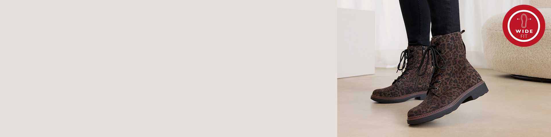 Brown lace-up boots with leopard print and black tights on beige bottom, with wide-fit logo in the corner