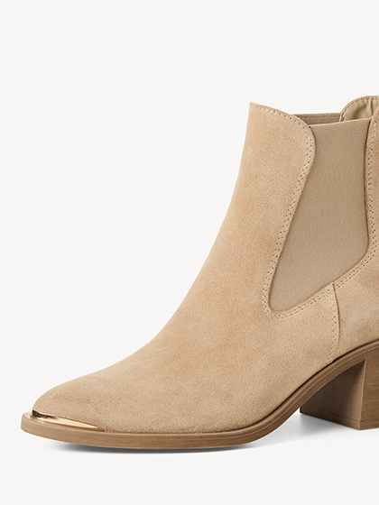 Beige suede Chelsea ankle boots with block heel against a white backdrop.