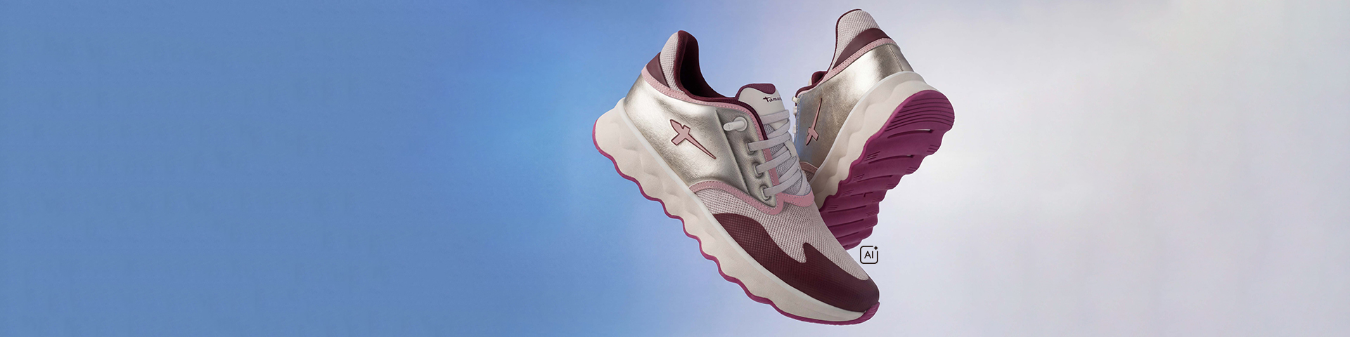 Tamaris trainers in silver, pink and burgundy with a pink sole floating against a blue and white background.