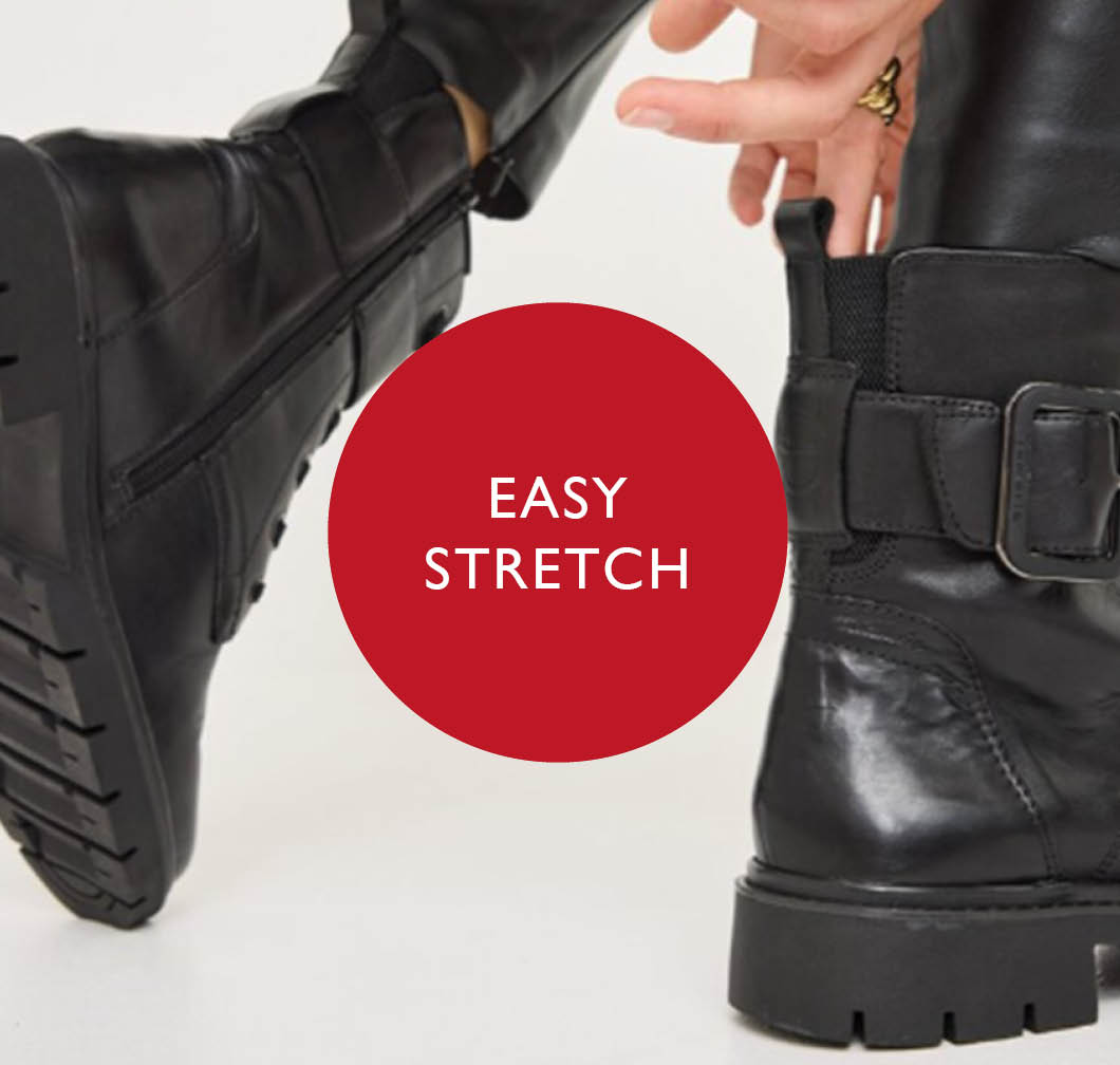 Black leather boot with buckle, a hand pulls on the shaft. Red circle with the text "Easy Stretch" in the centre.