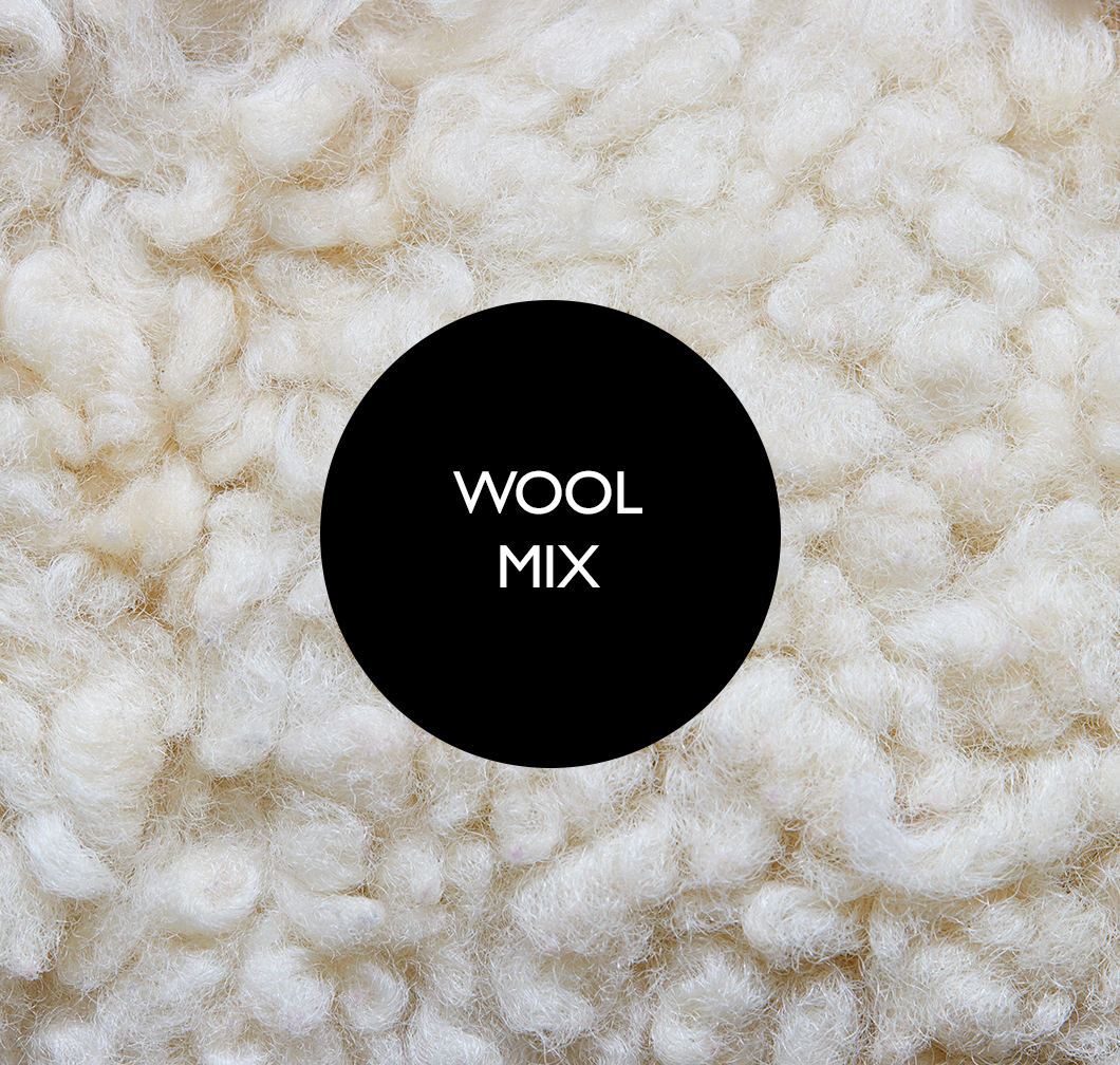Close-up of a cream-coloured, fluffy wool blend with a black circle in the centre bearing the text Wool Mix.