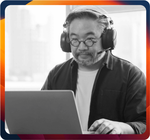 Older asian man on computer with headset