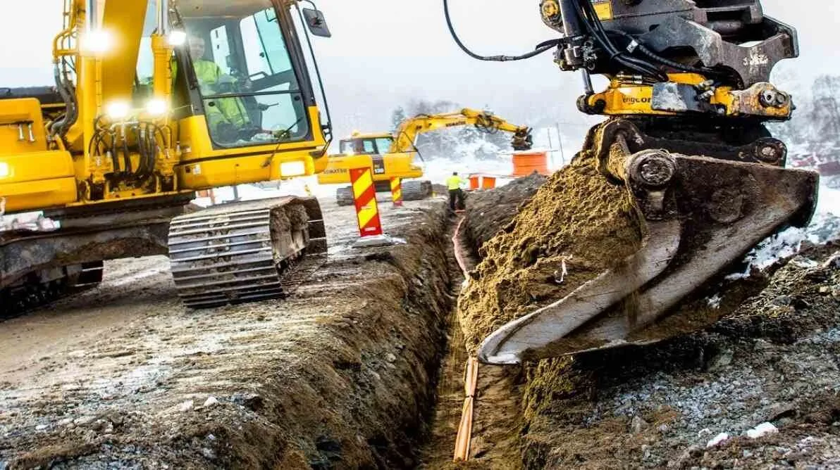 Fiberutbygging Gravemaskin som graver ned en fiberkabel