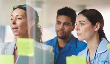 Image of nurse leaders in a dicussion within a hospital setting, relating to text that follows