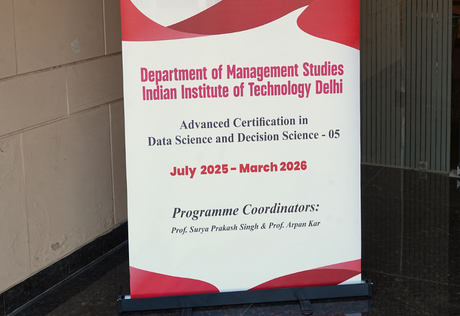 IIT Delhi campus standee displaying programme information for Applied AI, ML and Decision Science during campus immersion
