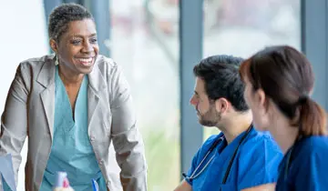 Image of nurse leaders in a dicussion within a hospital setting, relating to text that follows