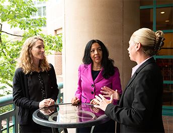 Image showing three corporate professionals in discussion