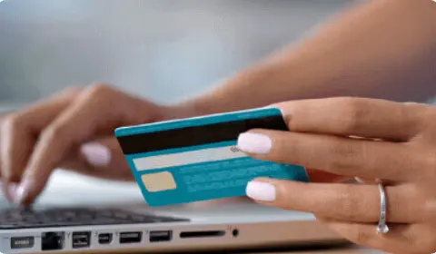 Image of a lady using a card to make a payment online to portray the company PayPal