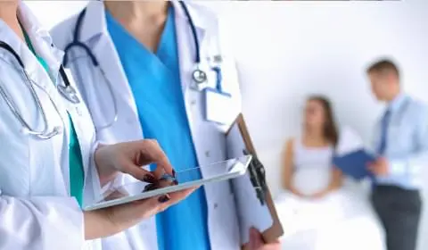 Image of two doctors looking at something in a tablet computer to portray the healthcare industry