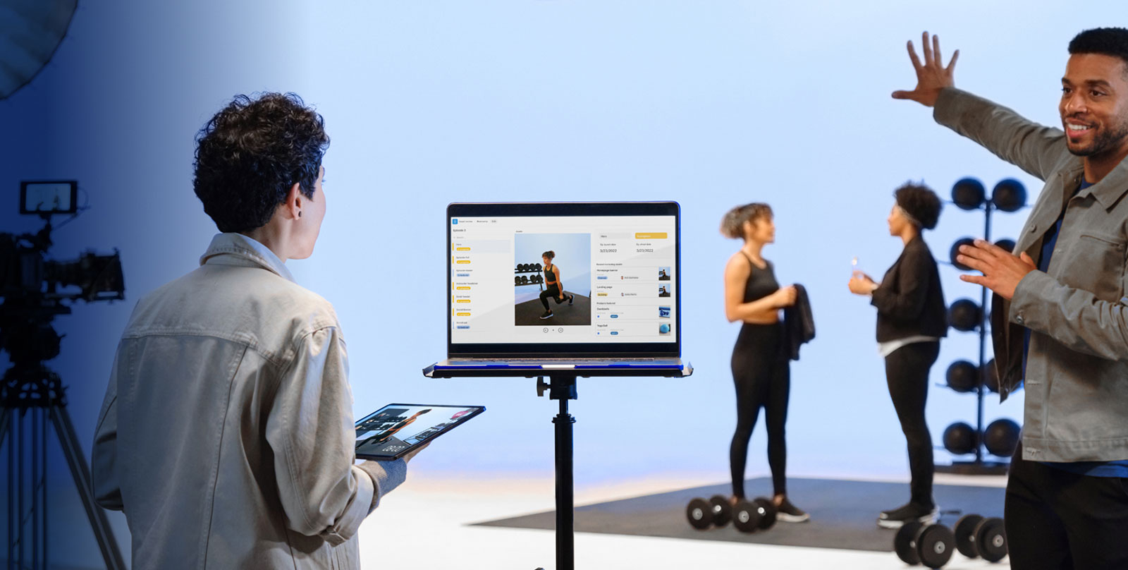 While shooting a fitness video, workers talk while seeing work as displayed in Airtable