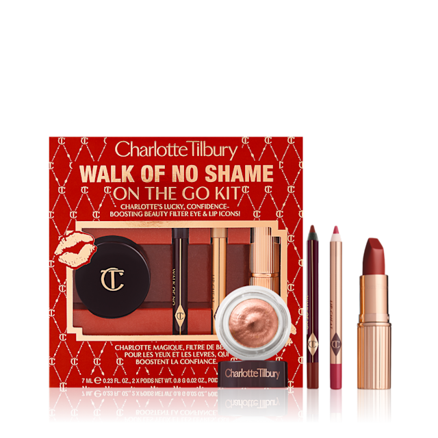 Eyeliner pencil in a berry-pink shade, lip liner pencil in berry-red shade, lipstick in a sleek, gold-coloured tube and russet gold cream eyeshadow in a petite jar with red-coloured gift box with text on it reads, 'Walk of no shame on the go'.