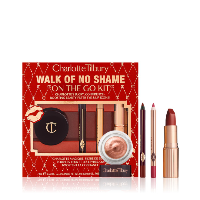 Eyeliner pencil in a berry-pink shade, lip liner pencil in berry-red shade, lipstick in a sleek, gold-coloured tube and russet gold cream eyeshadow in a petite jar with red-coloured gift box with text on it reads, 'Walk of no shame on the go'.