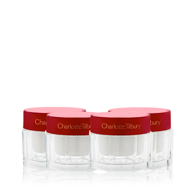 Limited Edition Year of Magic Skin still life A collection of pearly-white face creams in glass jars with eye-catching, red-coloured lids.