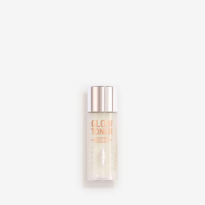 Mini Glow Toner Closed A large, clear bottle filled with luminous, cream-coloured watery toner with a silver-coloured lid.
