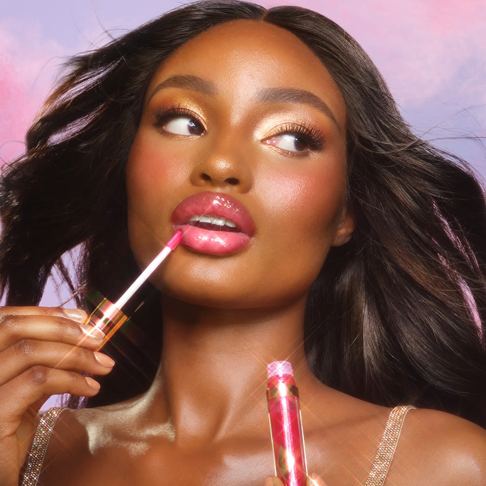 Blessing applying Jewel Lips lip gloss in Pinkgasm Sunset