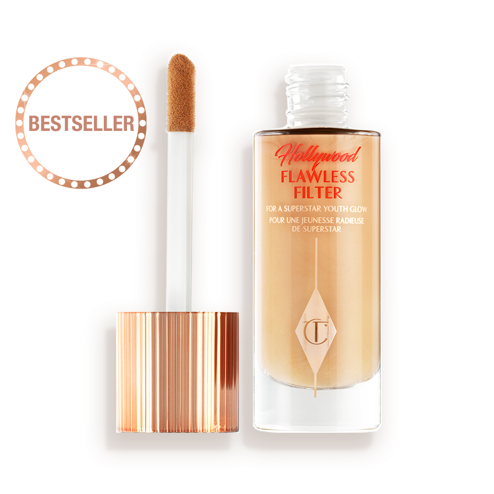 An open glow-boosting primer in a glass bottle with a rose gold-coloured lid with a doe-foot applicator.