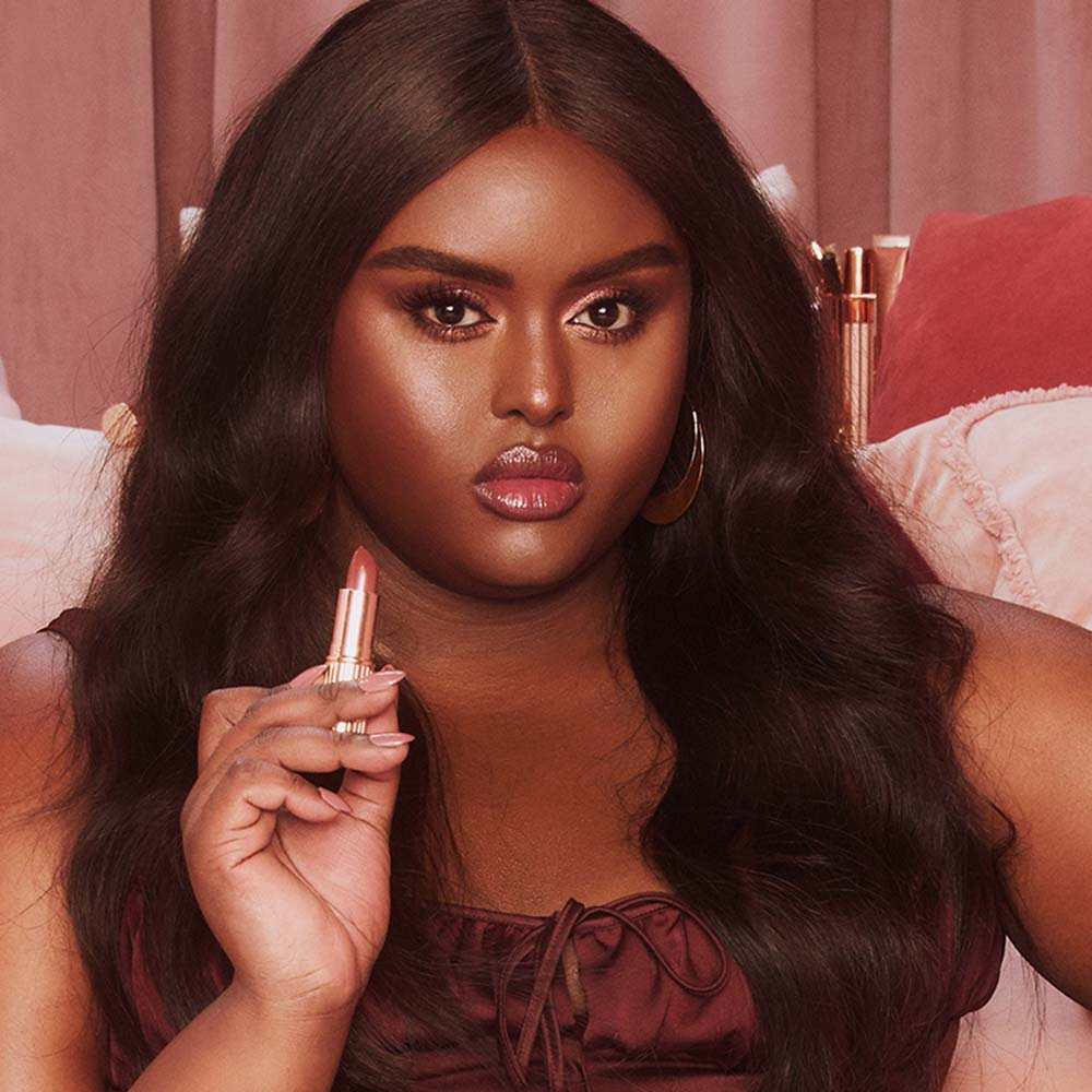 Model wearing Pillow Talk Intense pinky brown lipstick