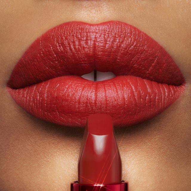 Lip close up of Mark of a Kiss muted red Matte Revolution lipstick