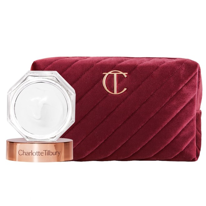 Red velvet makeup bag with the CT logo on the top in golden colour along with a white face cream in a glass jar with a gold-coloured lid. 