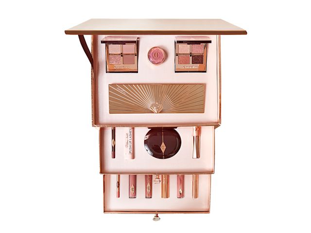 An open vault with lip glosses, eyeshadow palettes, eyeshadow pot, powder compact, mascaras, and lipsticks. 