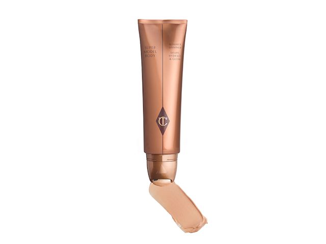 Swatch of a warm champagne body shimmer with its open, bronze-gold tube. 