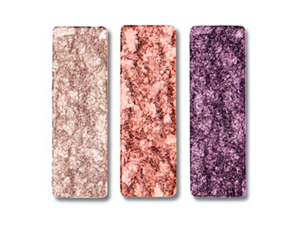Three shimmery eyeshadows in light champagne, dark rose gold, and amethyst purple. 