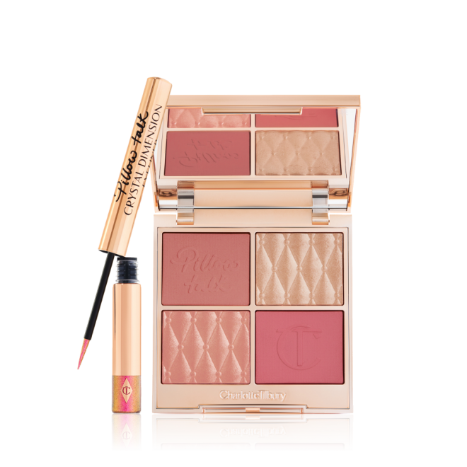 An open, face palette with matte and shimmery eyeshadows, blushes and highlighters in shades of pink and gold with a mirrored lid and a vivid pink eyeliner in gold packaging.