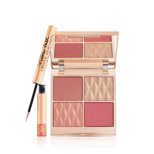 An open, face palette with matte and shimmery eyeshadows, blushes and highlighters in shades of pink and gold with a mirrored lid and a vivid pink eyeliner in gold packaging.