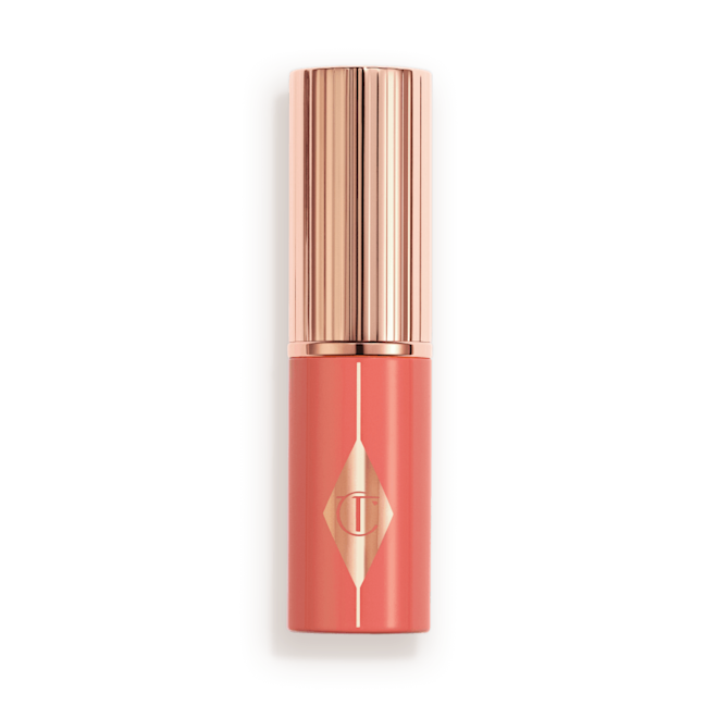 Unreal Blush Peachy Glow Closed Peach turning handle with rose-gold lid and detailing.