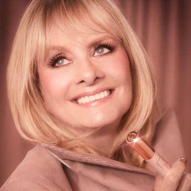 Pillow Talk Just Kissed Glow Kit on fair-tone model with mature skin Fair-tone model with mature skin and blue eyes wearing nude pink matte lipstick with shimmery rose gold eye makeup and soft nude pink, glowy blush.