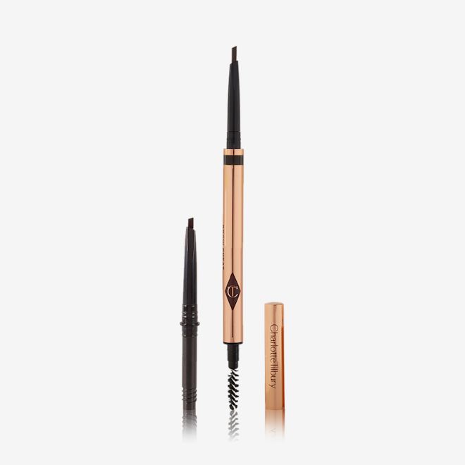 Brow Cheat in Natural Black Full Size and Refill Kit open A double-ended eyebrow pencil and spoolie brush duo in a black shade with gold-coloured packaging and the refill besides it.