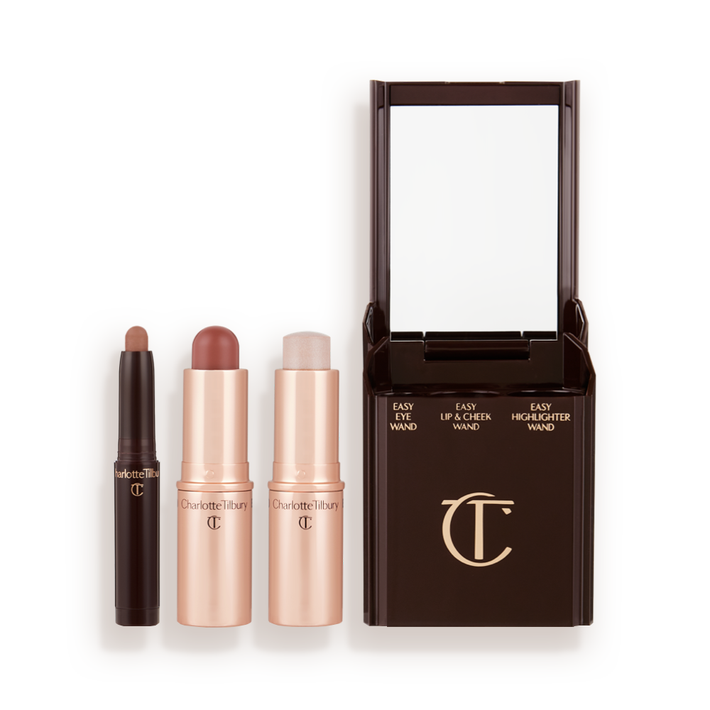 An open shadow stick in a matte nude brown shade, a lip and cheek blush stick in a soft pink shade, and highlighter stick in an opal shade.