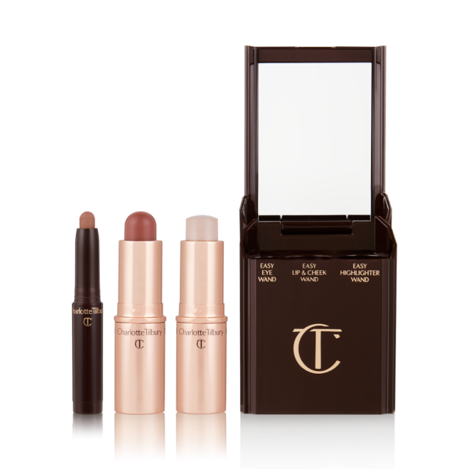 An open shadow stick in a matte nude brown shade, a lip and cheek blush stick in a soft pink shade, and highlighter stick in an opal shade.