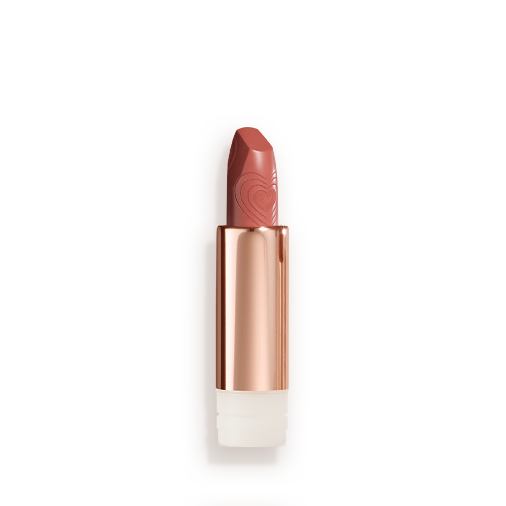 A  lipstick refill with its lid removed in a nude peach shade in a gold-coloured tube.