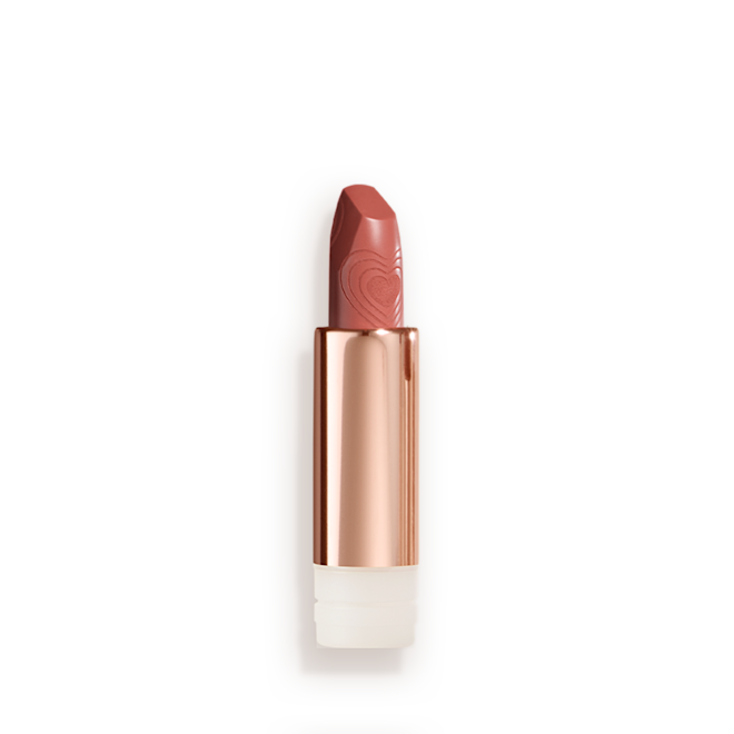 K.I.S.S.I.N.G Lipstick In Nude Romance refill A lipstick refill with its lid removed in a nude peach shade in a gold-coloured tube.