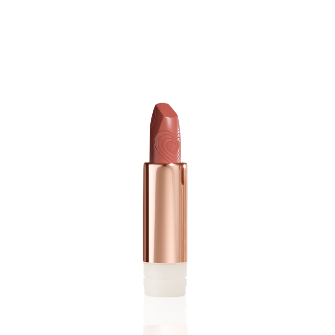 A  lipstick refill with its lid removed in a nude peach shade in a gold-coloured tube.