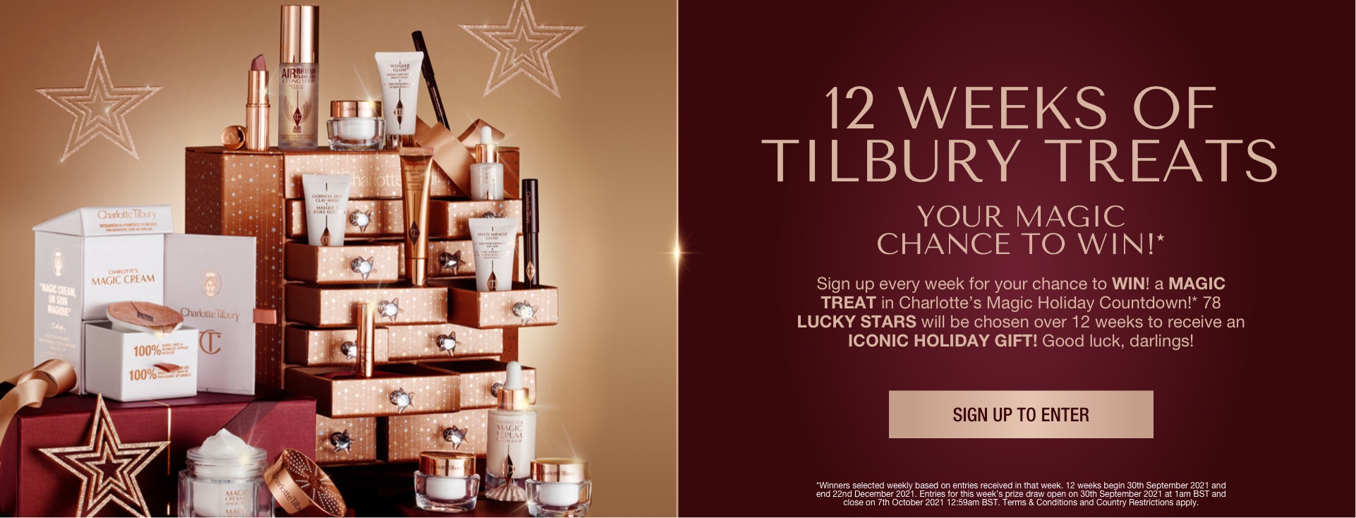 Banner with a golden-coloured chest with twelve drawers with shiny, silver-coloured star handles with the products inside displayed, hich include makeup primers, clay mask, face cream, liquid highlighter wand, setting spray, lipstick. mascara, chubby eyeshadow stick, lip liner pencil, and eyeliner, and text on the banner that reads, '12 weeks of Tilbury Treats. Sign up to enter'