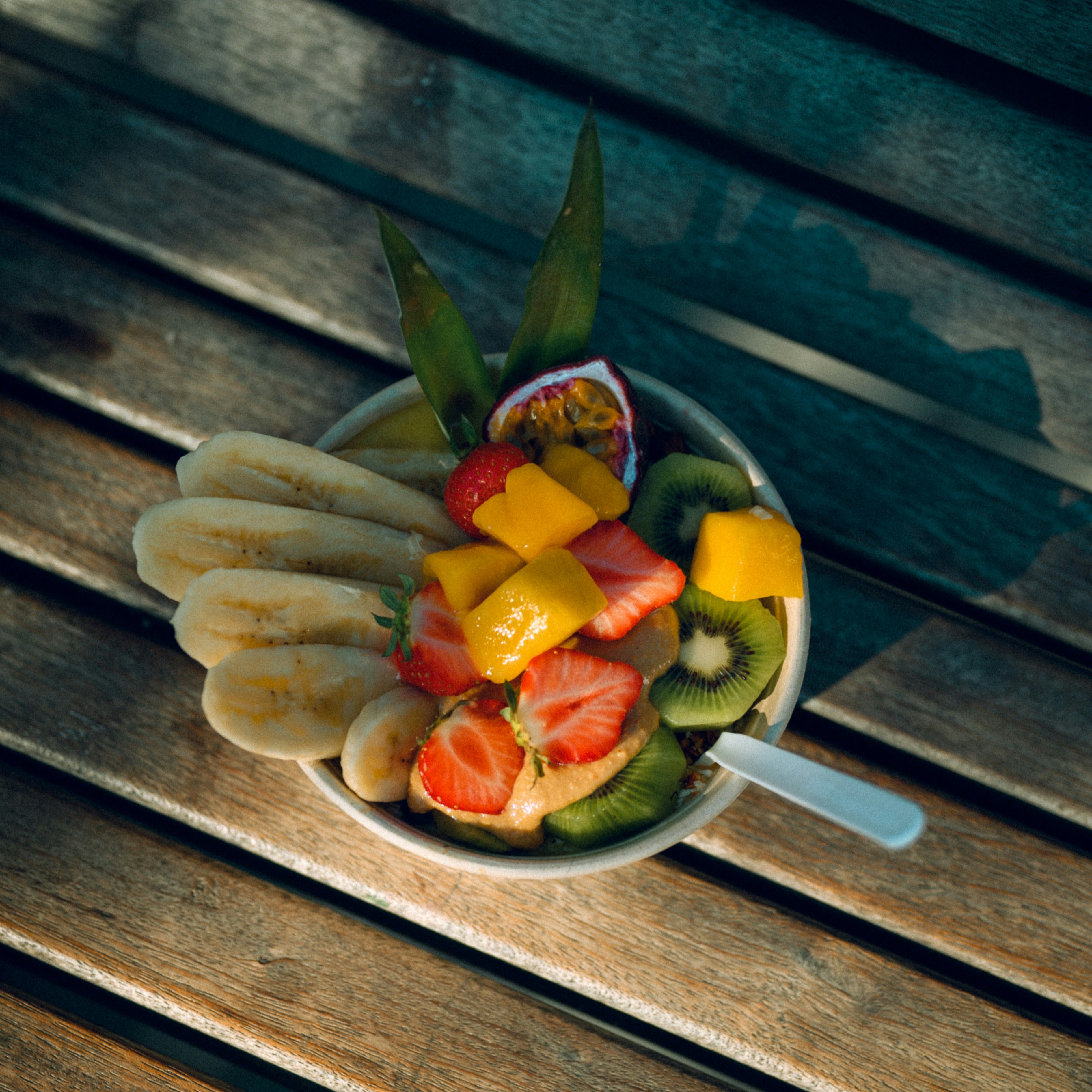 A bowl with starwberries, mango, kiwi and bananas for a more healthy option.